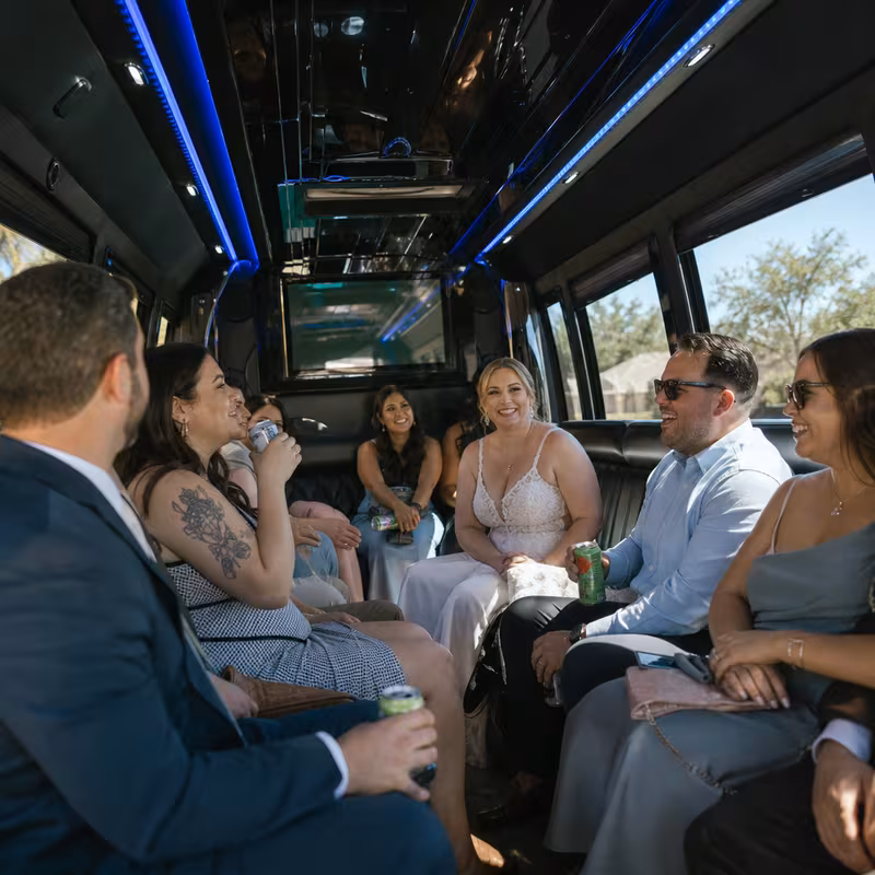 Wedding guests seated inside a Albuquerque party bus