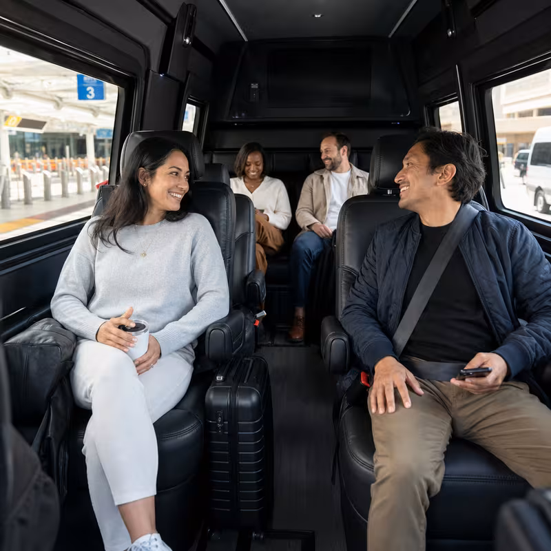 Passengers loading luggage while boarding an Albuquerque group shuttle