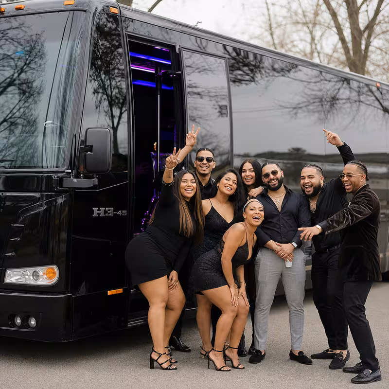 Group boarding a white charter bus for Birthday Transportation transportation in Albuquerque