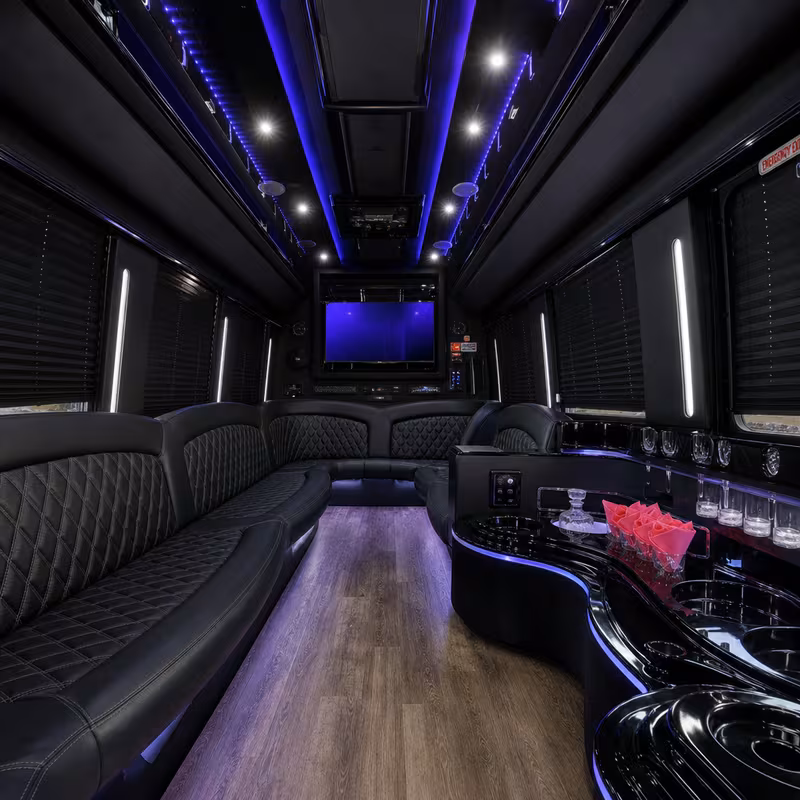 Party bus interior with wraparound leather seating and LED lighting in Albuquerque