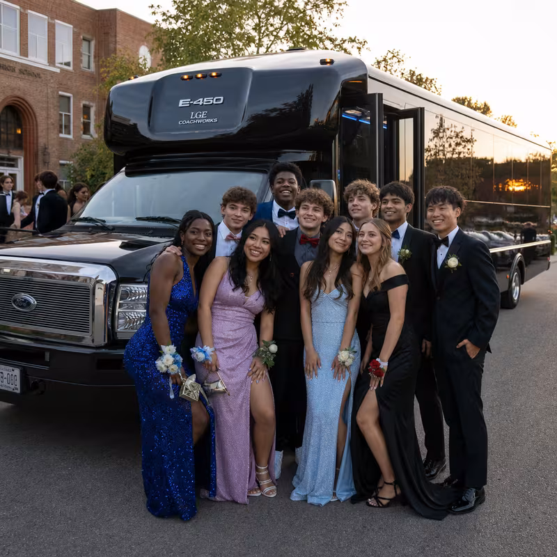 Group boarding a white charter bus for Prom & Homecoming Transportation transportation in Albuquerque