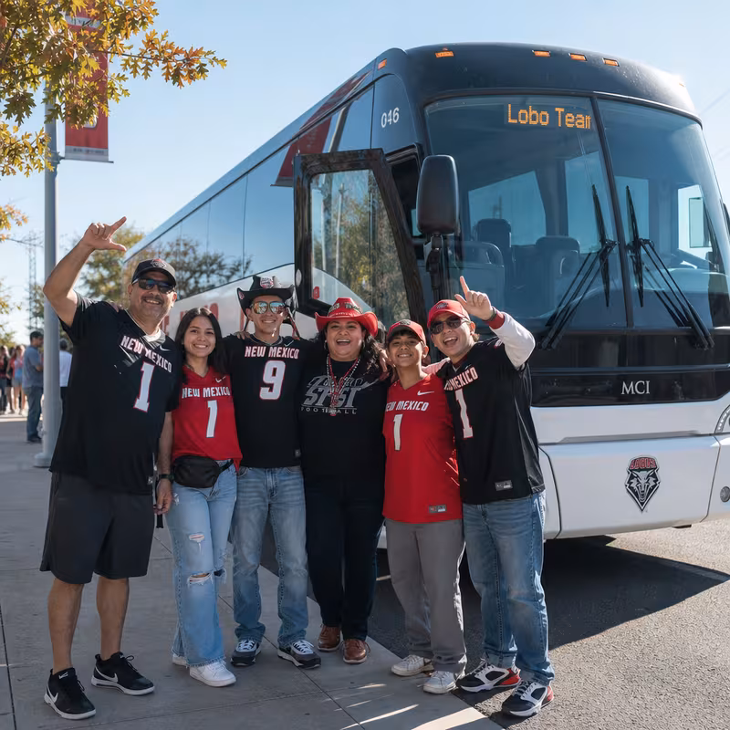 Passengers loading luggage while boarding an Albuquerque group shuttle
