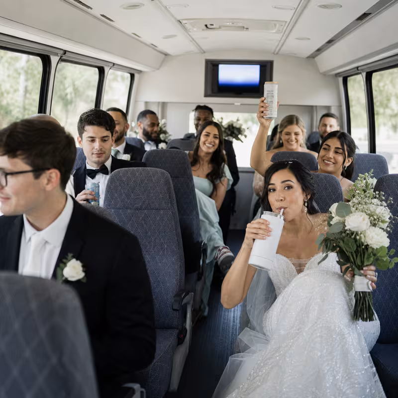 Group boarding a white charter bus for Wedding Transportation transportation in Albuquerque