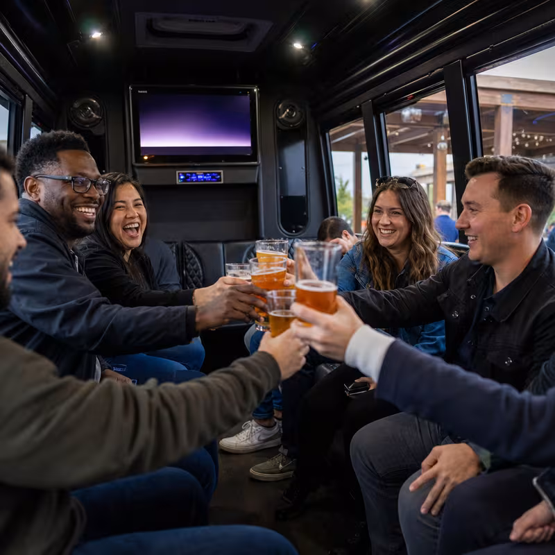 Group boarding a white charter bus for Winery & Brewery Tour Transportation transportation in Albuquerque