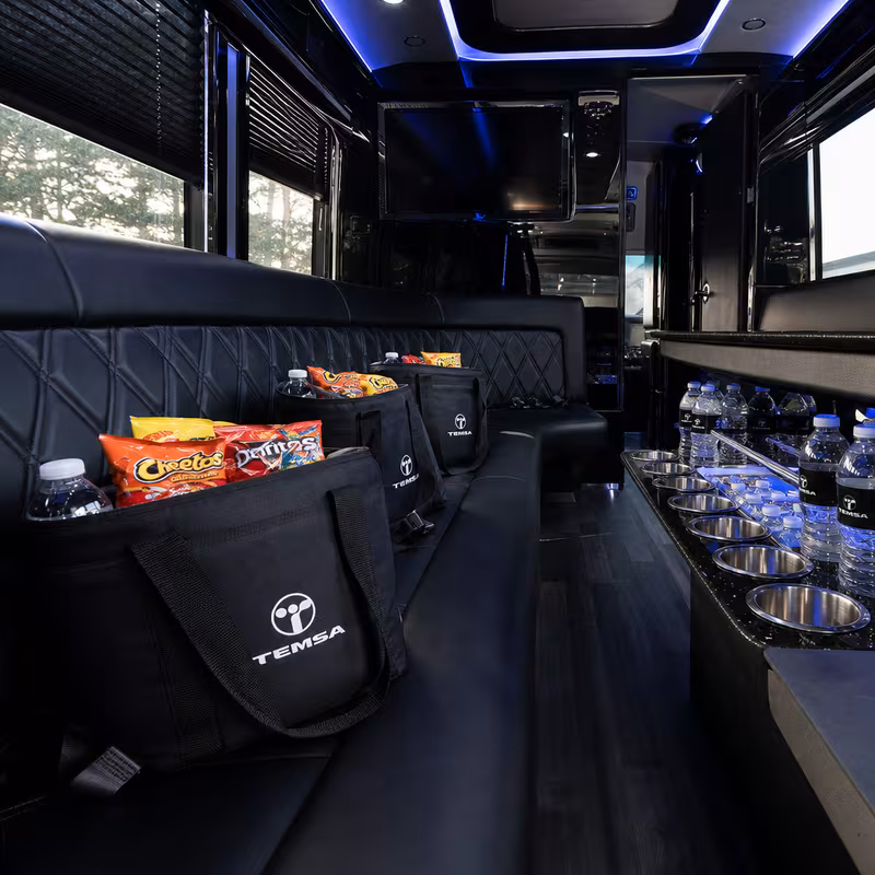 Party bus interior with wraparound leather seating and LED lighting in Albuquerque
